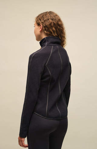 Damen Fleecejacke Wera-BF in der Farbe Midnight von Frauenschuh, nachhaltig produziert, von einem Model getragen. Rückansicht der Jacke, die ideal für alle Jahreszeiten ist, mit modernem Design und Zwei-Wege-Reißverschluss für zusätzlichen Komfort.
