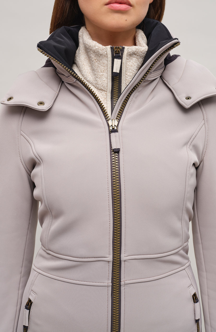 Performance Ski-Overall Kate-S aus Schöller Softshell, enganliegende Passform, Taillenbetonung durch angedeuteten Gürtel, abnehmbare Kapuze, Oberkörper gefüttert, markanter Zip, zwei Taschen mit markantem Zip, Skipasstasche mit nahtfeinem Zip, klassische Frauenschuh Features wie Kantenschutz aus Alcantara-Leder, enganliegende Ärmelbündchen und Schneefang. Robustes, elastisches Material, wasser- und windabweisend, ideal für die Skipiste. In der Farbe Hellbraun (Farbe: cashmere)